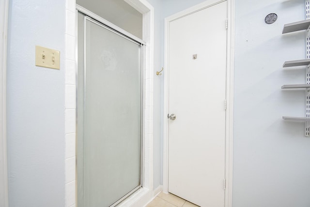 bathroom with tile patterned floors and walk in shower