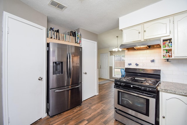 kitchen with appliances with stainless steel finishes, a textured ceiling, dark wood-type flooring, white cabinets, and hanging light fixtures