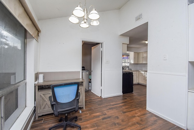 office area with a notable chandelier and dark hardwood / wood-style flooring