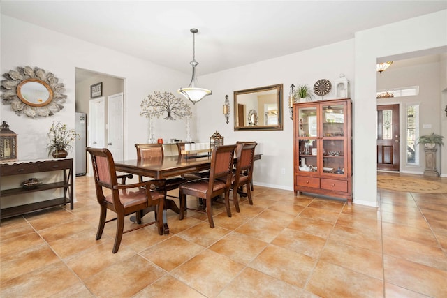 dining room featuring light tile patterned floors and a chandelier