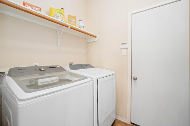 clothes washing area featuring washer and dryer and laundry area