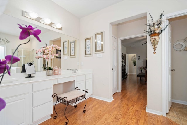 bathroom featuring ceiling fan, vanity, and hardwood / wood-style floors