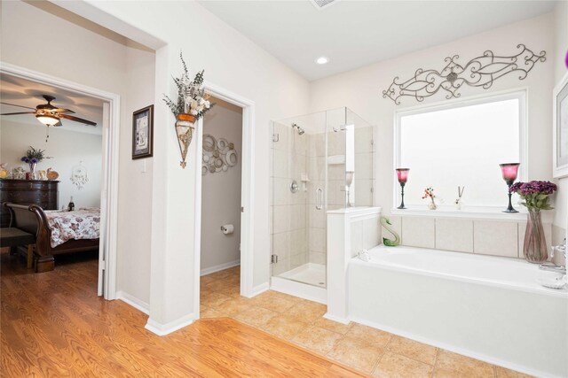 bathroom with ceiling fan, independent shower and bath, and hardwood / wood-style flooring