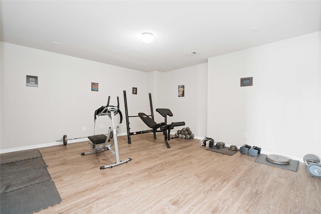 workout room featuring light wood-type flooring