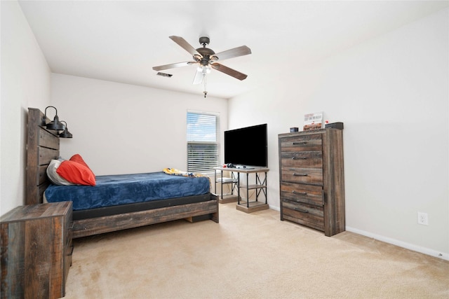 bedroom with ceiling fan and light carpet