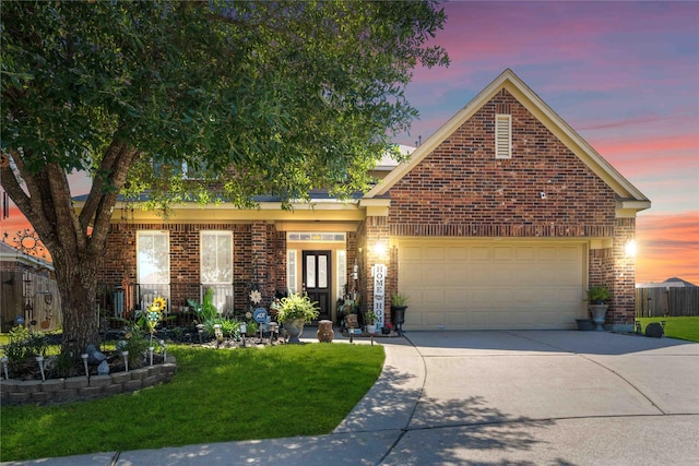 view of front of home with brick siding, concrete driveway, an attached garage, fence, and a front yard