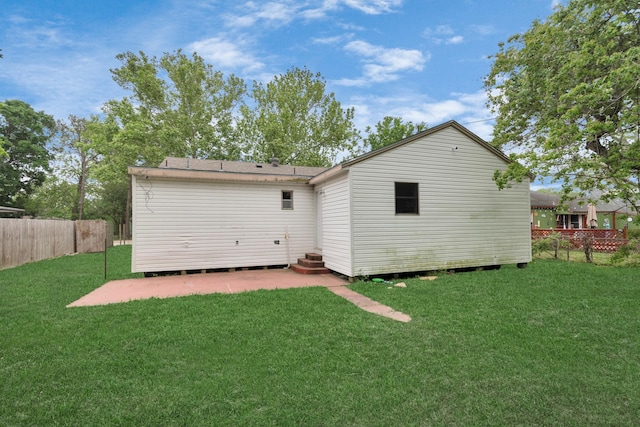 back of house featuring a yard and a patio