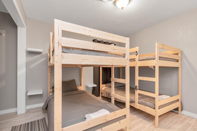 unfurnished bedroom featuring wood-type flooring and a textured ceiling