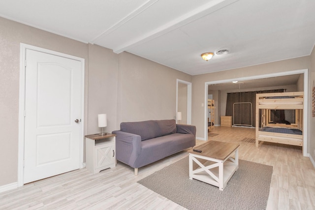 living room with hardwood / wood-style floors and beam ceiling