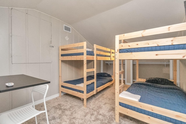 bedroom featuring carpet floors and vaulted ceiling