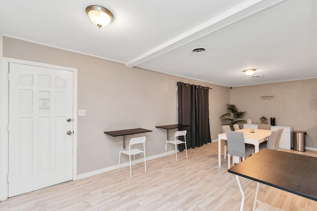 dining space with light hardwood / wood-style flooring