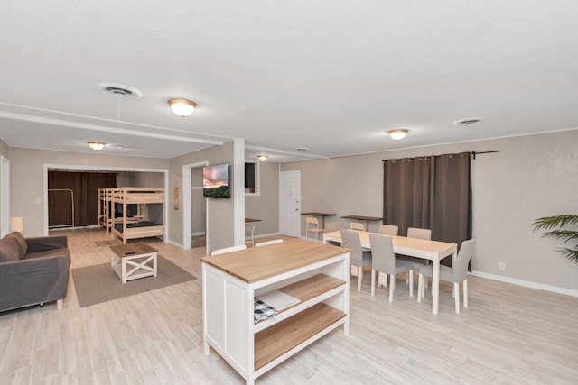 kitchen with butcher block countertops and light hardwood / wood-style flooring