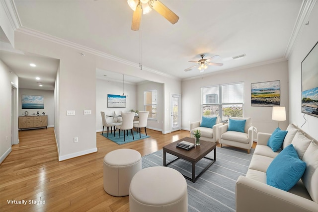 living room with wood-type flooring, ceiling fan, and crown molding