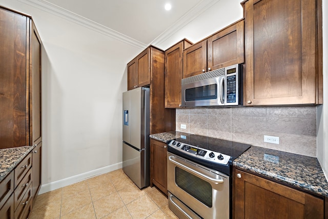 kitchen featuring light tile patterned floors, backsplash, stainless steel appliances, and dark stone countertops