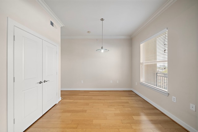 interior space featuring light hardwood / wood-style floors and crown molding