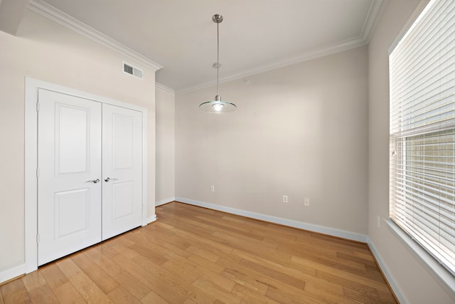 spare room with crown molding and light hardwood / wood-style flooring