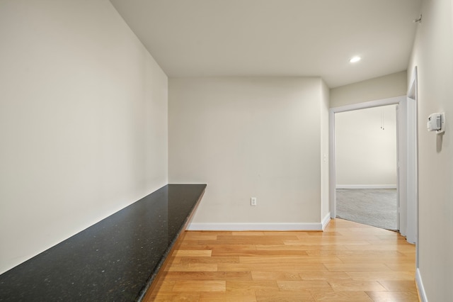 corridor with light hardwood / wood-style flooring