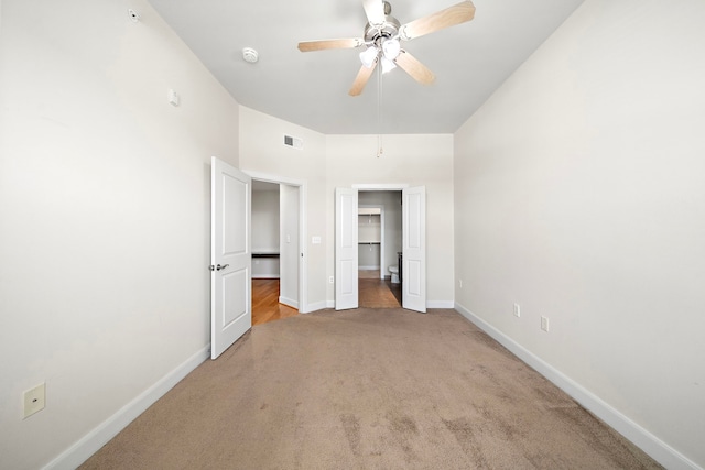 unfurnished bedroom with light colored carpet and ceiling fan