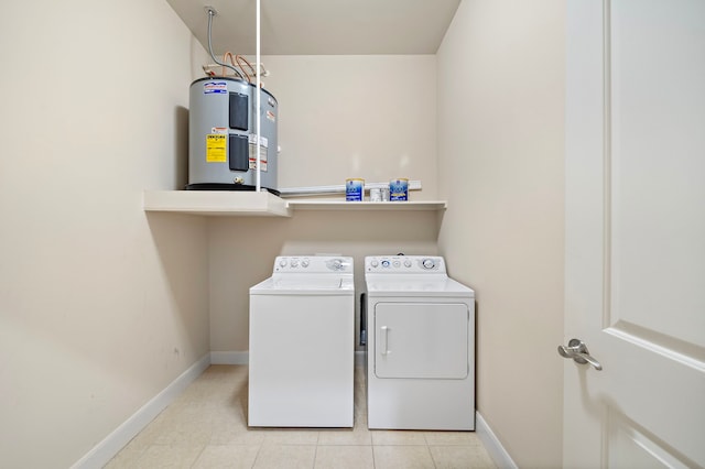 clothes washing area featuring separate washer and dryer, electric water heater, and light tile patterned floors