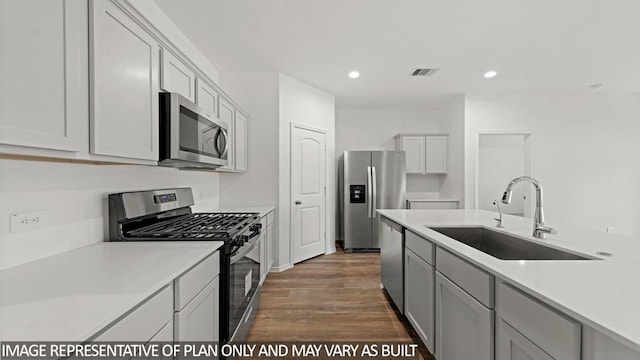 kitchen featuring dark hardwood / wood-style floors, sink, and stainless steel appliances