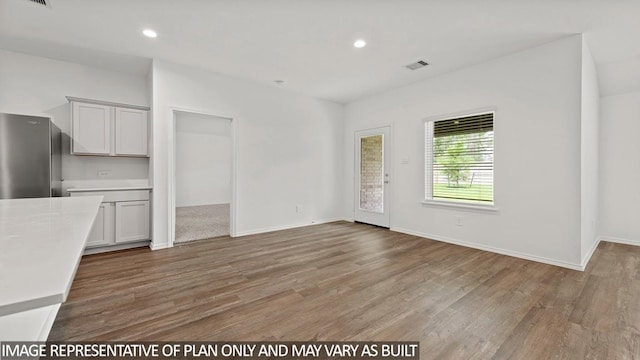 unfurnished living room with hardwood / wood-style floors