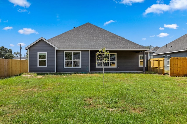 rear view of house with a lawn