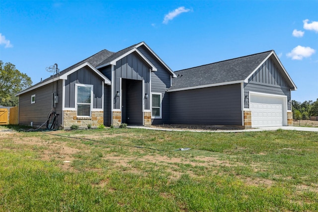 view of front of house with a garage and a front lawn