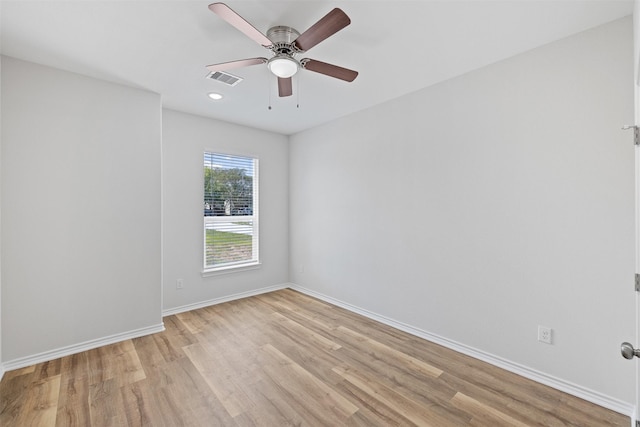 empty room with ceiling fan and light hardwood / wood-style floors