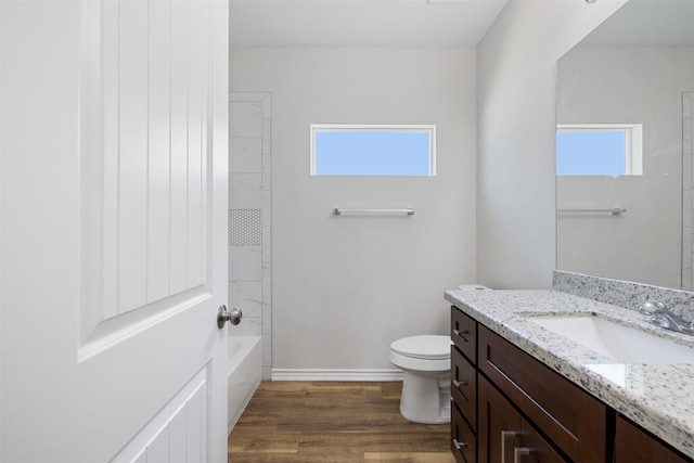 full bathroom featuring hardwood / wood-style floors, vanity, a healthy amount of sunlight, and toilet