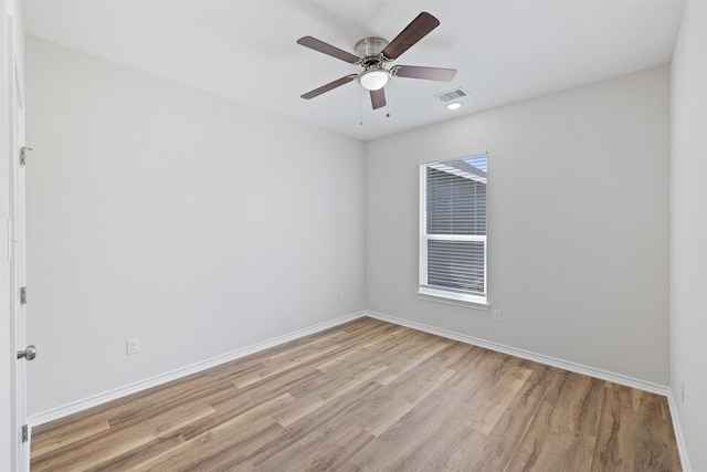 empty room featuring ceiling fan and light hardwood / wood-style floors