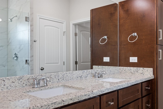 bathroom featuring vanity and an enclosed shower