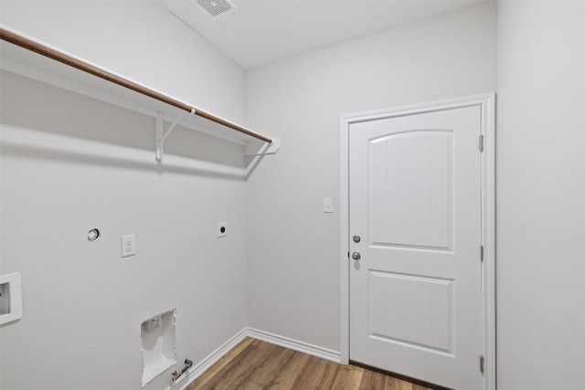 clothes washing area featuring washer hookup, dark hardwood / wood-style flooring, gas dryer hookup, and electric dryer hookup