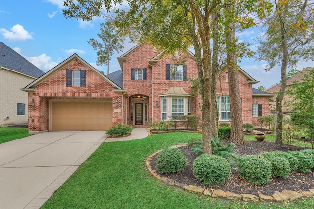 view of front property featuring a garage and a front yard