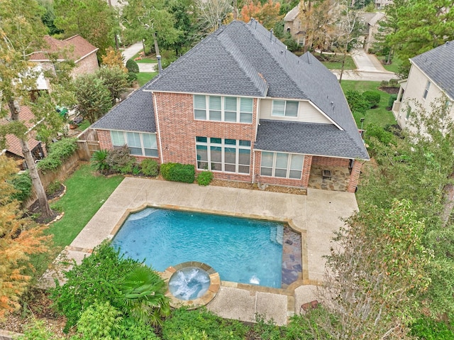 view of swimming pool featuring an in ground hot tub and a patio