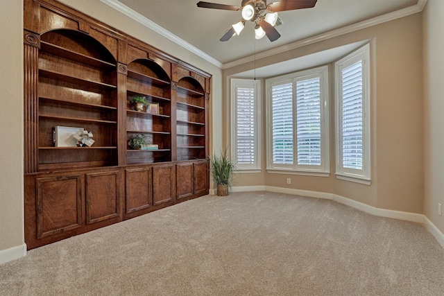 interior space with light colored carpet, a wealth of natural light, and crown molding