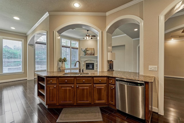 kitchen with dishwasher, light stone counters, ceiling fan, and sink