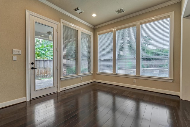 interior space featuring plenty of natural light, ceiling fan, crown molding, and dark wood-type flooring