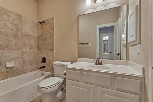 full bathroom with vanity, tile patterned floors, tiled shower / bath combo, and toilet