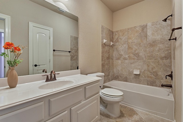 full bathroom with vanity, toilet, and tiled shower / bath