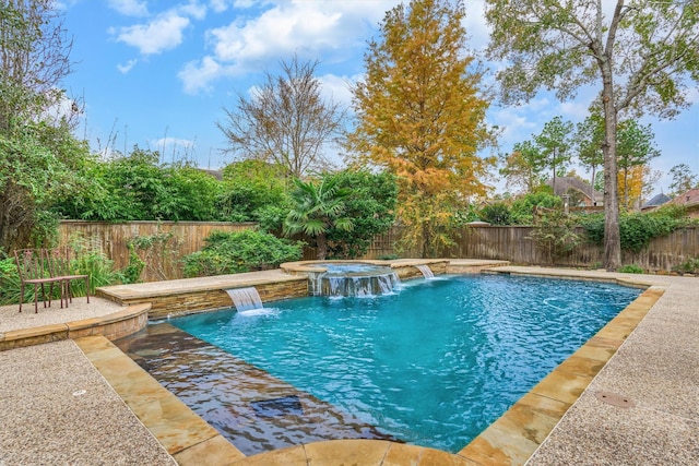 view of swimming pool featuring a patio area, pool water feature, and an in ground hot tub