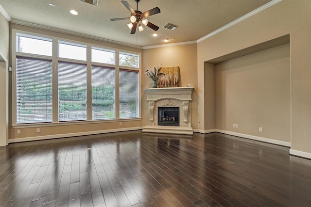 unfurnished living room featuring ceiling fan, dark hardwood / wood-style flooring, a textured ceiling, a fireplace, and ornamental molding