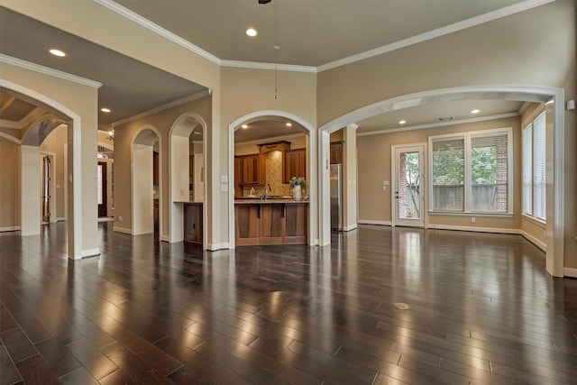 interior space featuring dark hardwood / wood-style flooring, crown molding, and sink