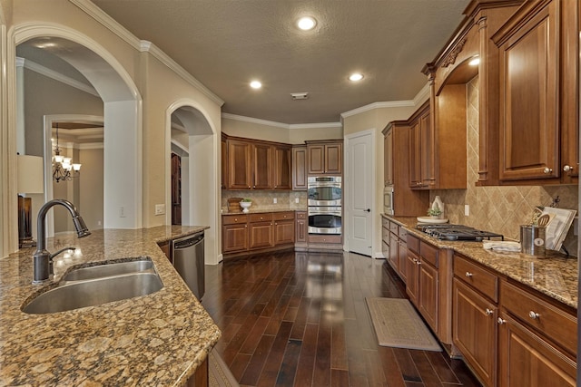 kitchen featuring tasteful backsplash, light stone counters, sink, and stainless steel appliances