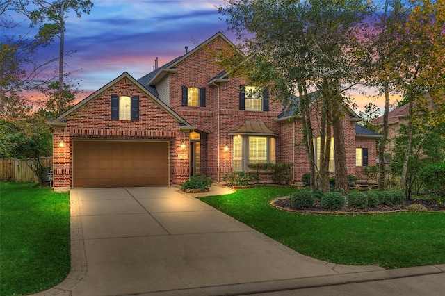 view of front facade with a garage and a lawn