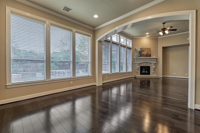 unfurnished living room with ceiling fan, dark hardwood / wood-style flooring, and ornamental molding