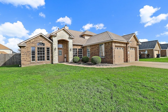 view of front of house with a garage and a front lawn