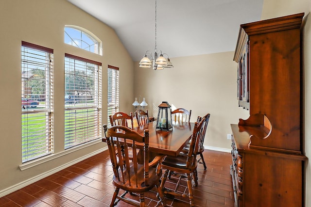 dining area with dark hardwood / wood-style flooring, plenty of natural light, lofted ceiling, and a notable chandelier