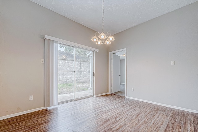 spare room featuring hardwood / wood-style flooring and a healthy amount of sunlight