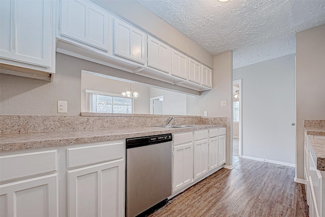 kitchen featuring white cabinets, dishwasher, light hardwood / wood-style floors, and a textured ceiling