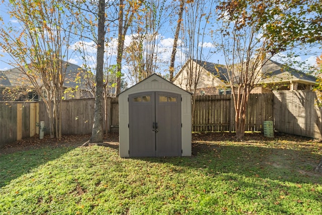 view of outbuilding with a yard and central AC unit